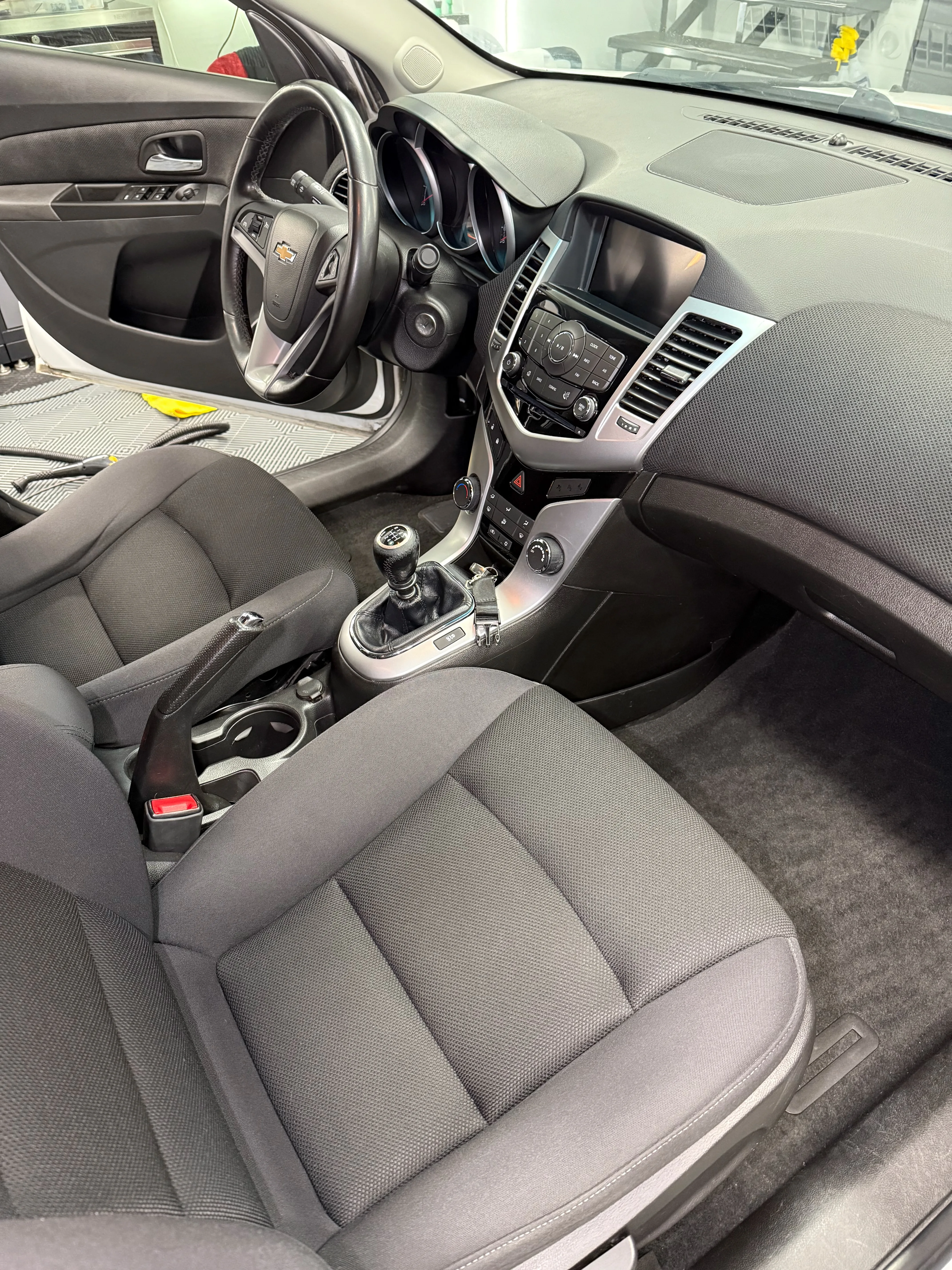 Interior detailing after — passenger side with spotless carpets and clean trim