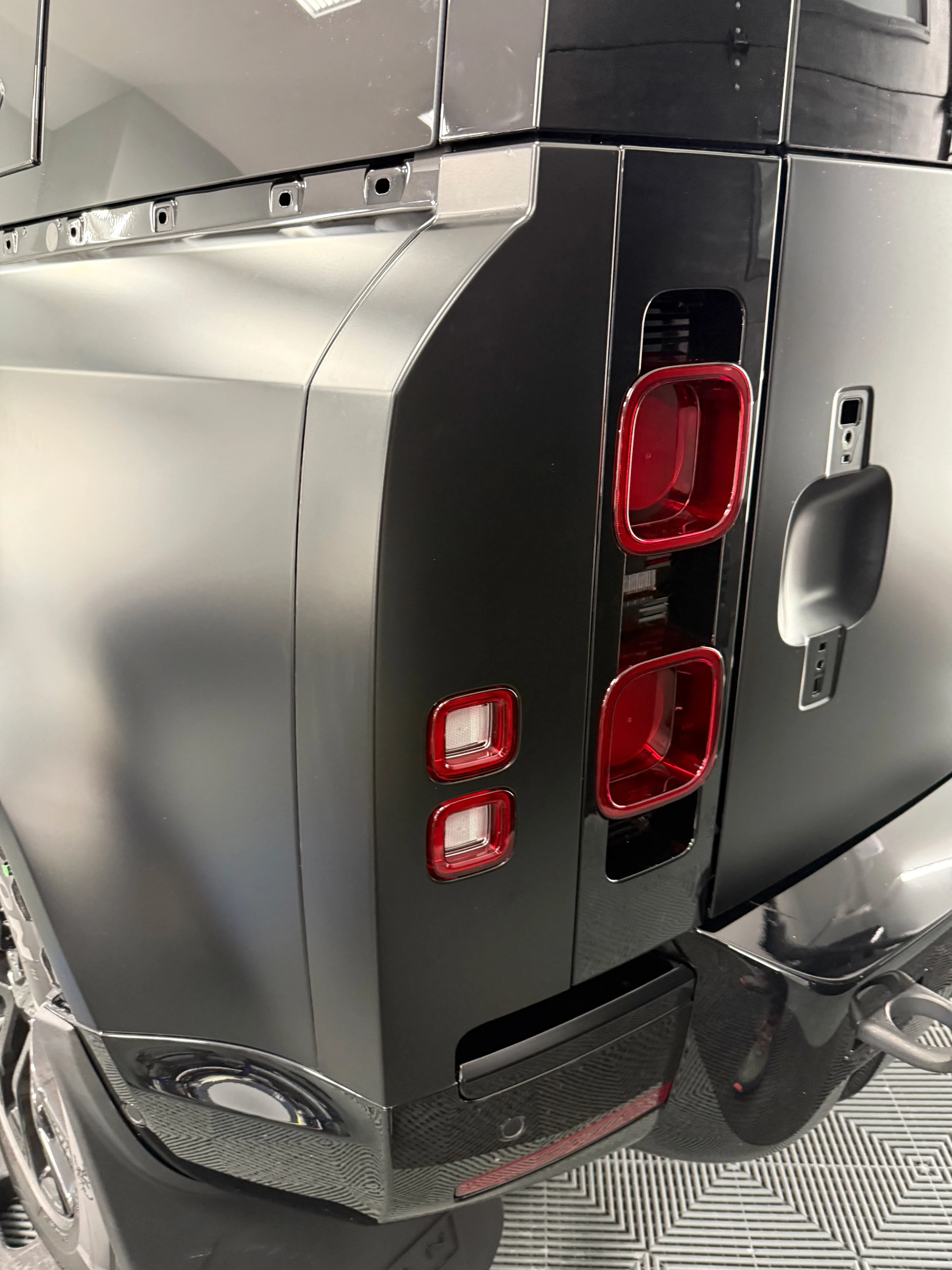 Finished matte PPF installation on Land Rover Defender rear — seamless satin finish with tail lights