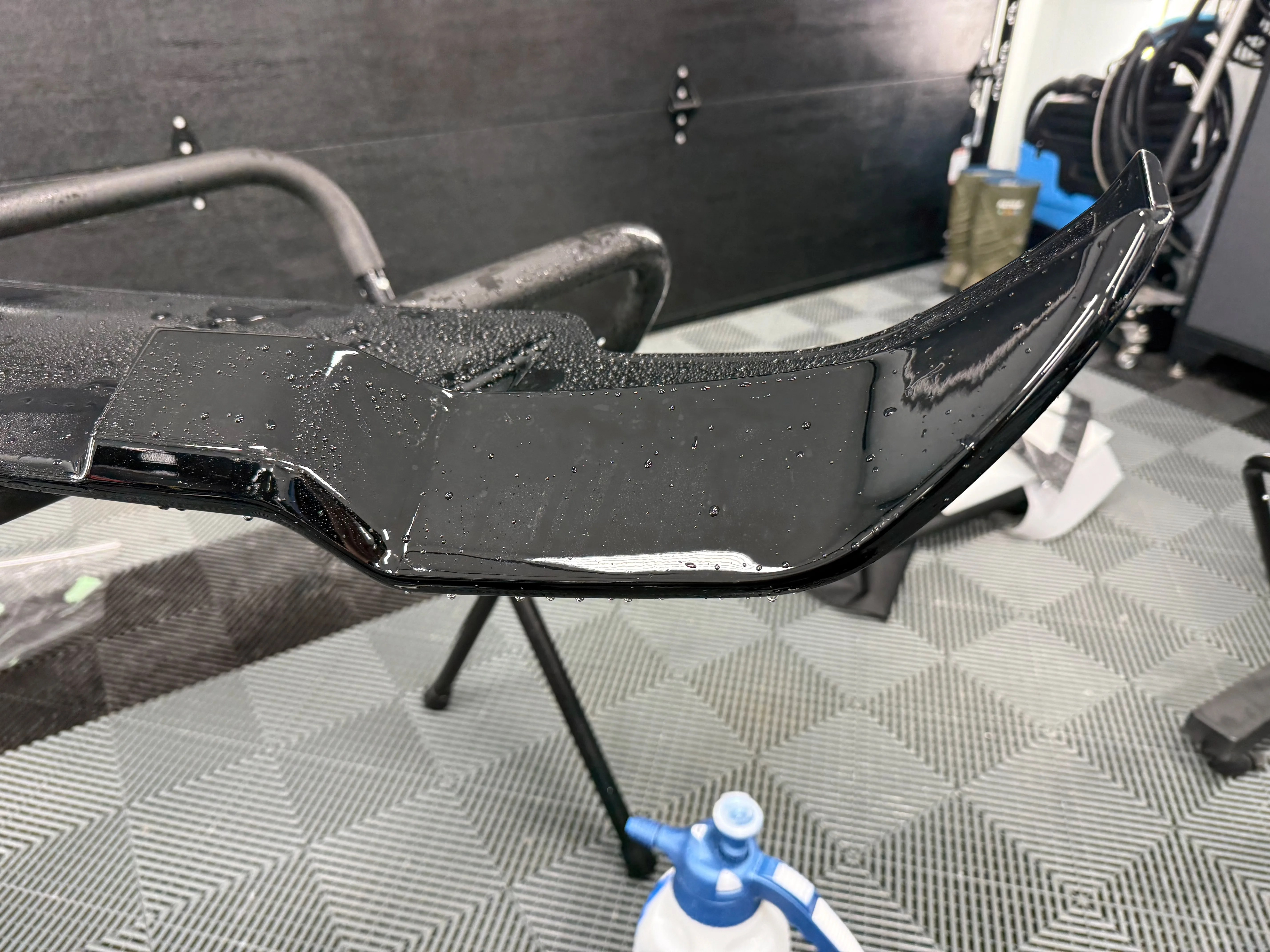 Rear spoiler after PPF installation — seamless finish with no visible edges