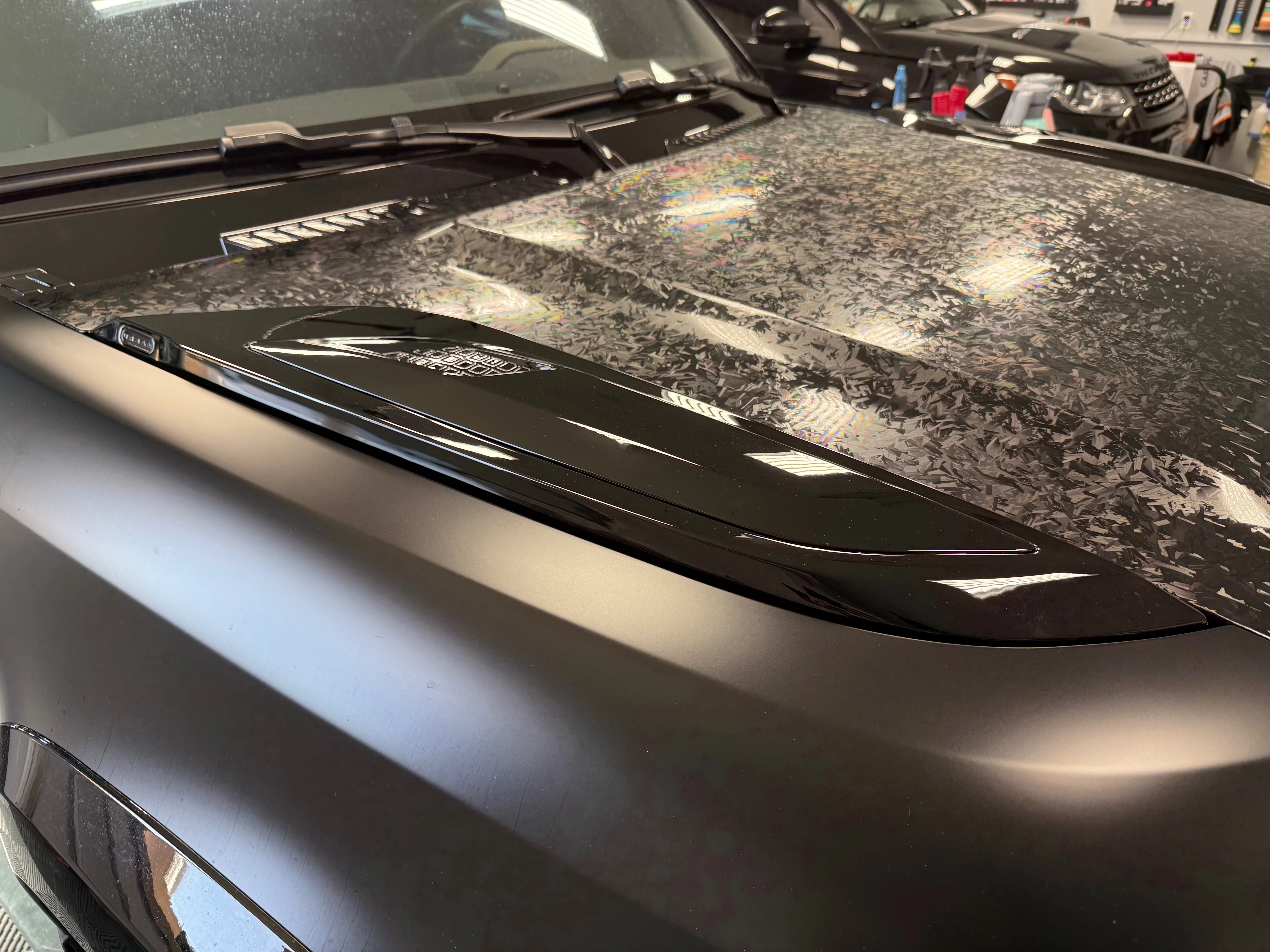 Urban Automotive forged carbon hood vents installed on Land Rover Defender with matte PPF finish